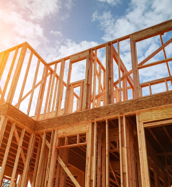 New residential construction home framing against a blue sky. Roofing construction. Wooden construction